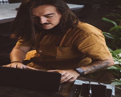 man over 40 working on a laptop at home in Indonesia