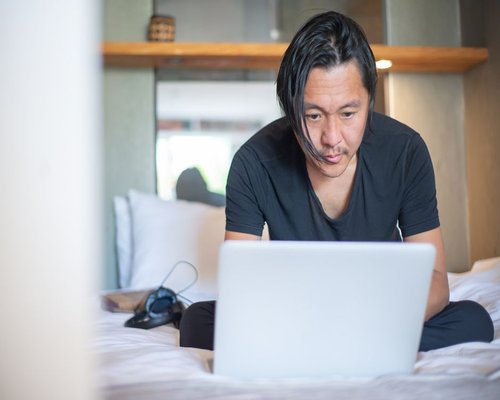 man over 40 working on a laptop at home in Indonesia